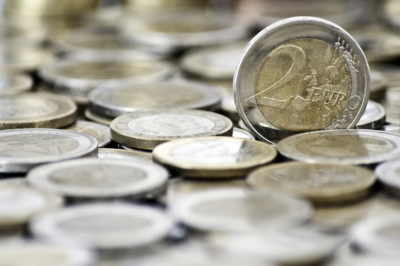Grungy 2 euro coin with coins background